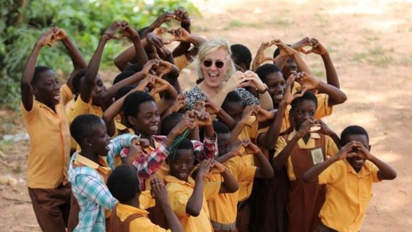 Kids in Africa and woman forming hears with their hands Kids in Africa and woman forming hears with their hands