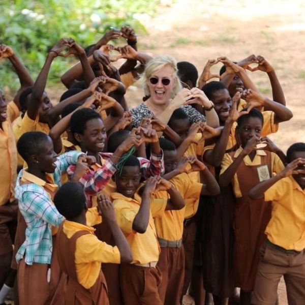 Kids in Africa and woman forming hears with their hands Kids in Africa and woman forming hears with their hands