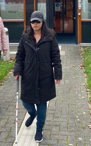 visio-het-loo-erf-Athittiya-Auaychai-loopt-met-stok-begeleid-door-medewerkerk.jpg visio-het-loo-erf-Athittiya-Auaychai-loopt-met-stok-begeleid-door-medewerkerk.jpg